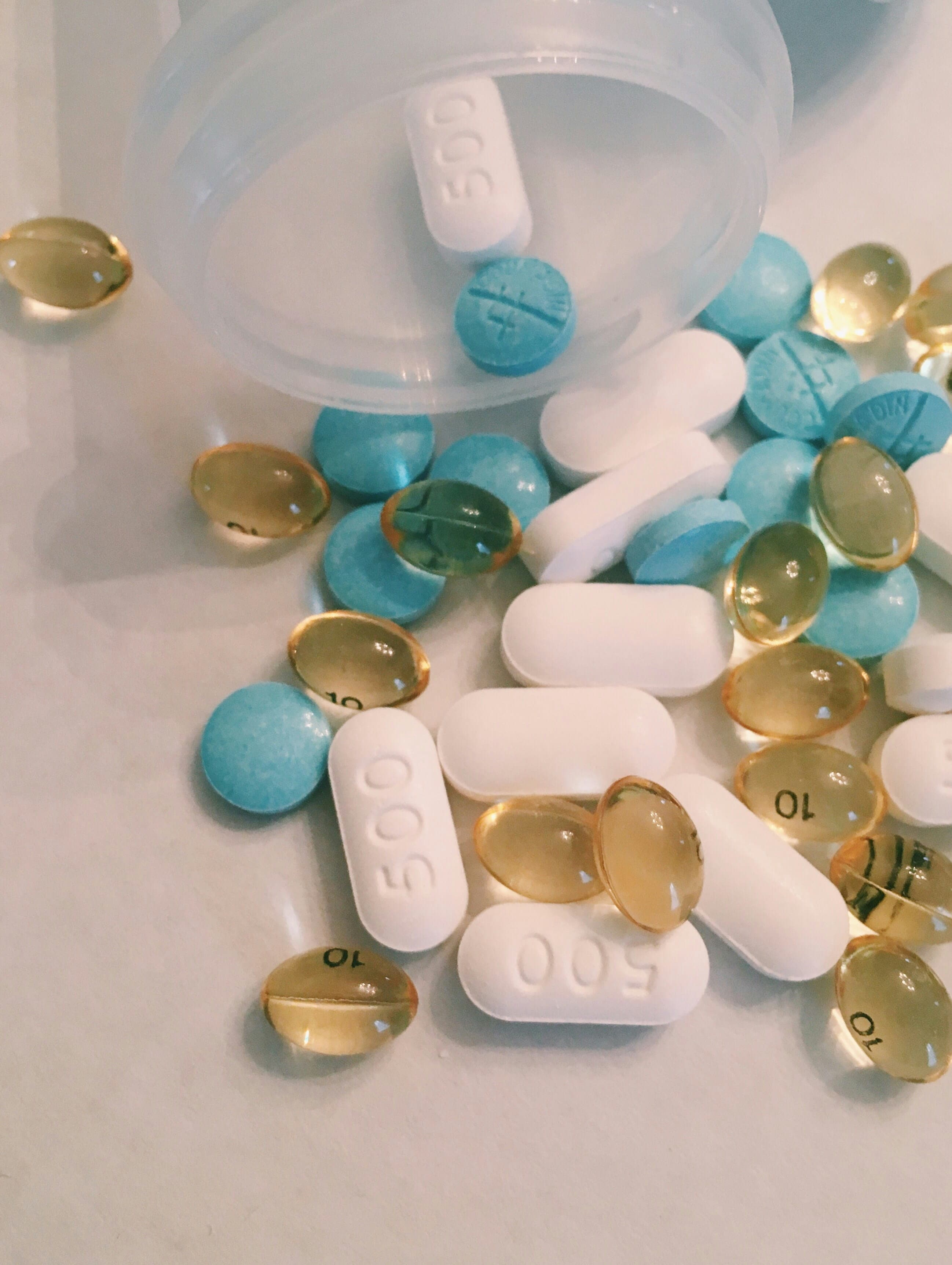 Vitamin capsules spilling from a bottle